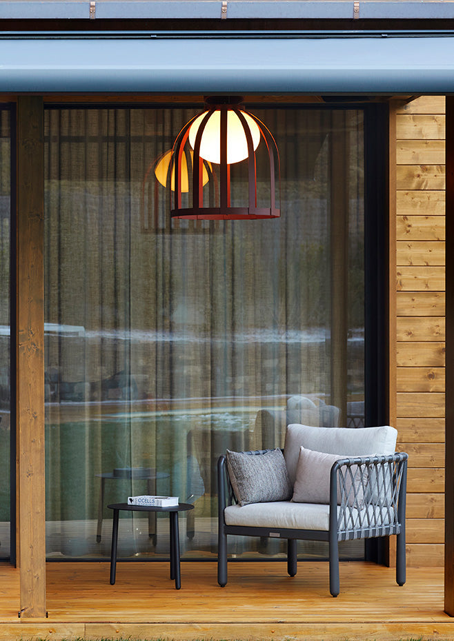 Bols ceiling light in ox red over outdoor seating area