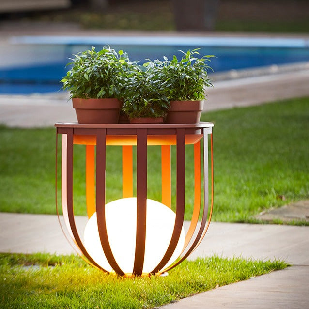 Bols floor lamp short in ox red with potted plants on top on lawn by pool