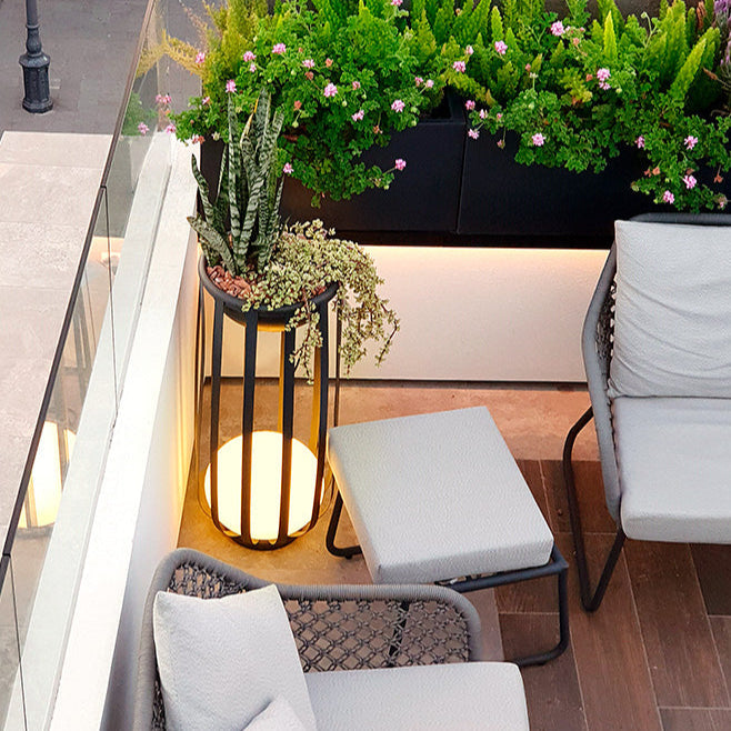 Bols outdoor floor lamp in black with plants in corner of terrace