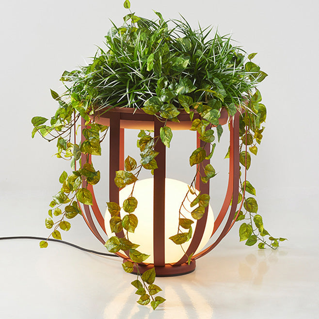 Bols_outdoor_floor_lamp_short_in_red_thumbnail with top accessory and greenery