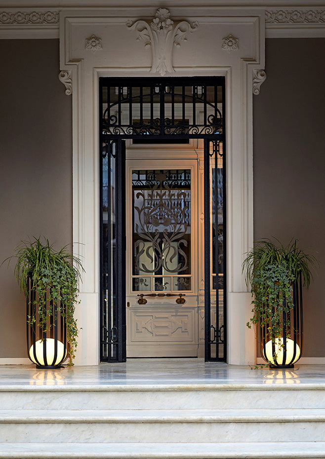 Bols outdoor floor lamps in tall black flanking door