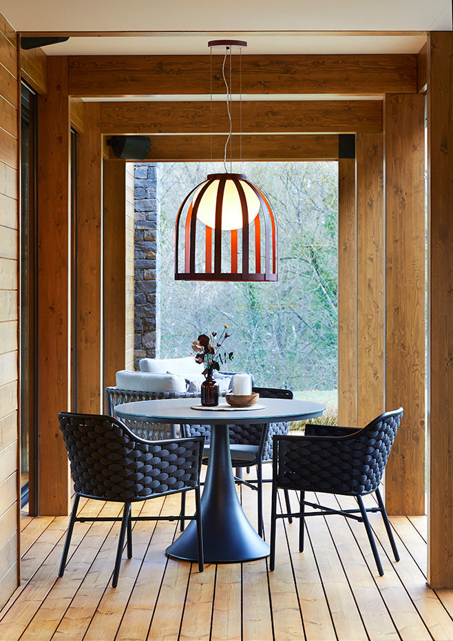 Bols pendant light in ox red in covered porch over table