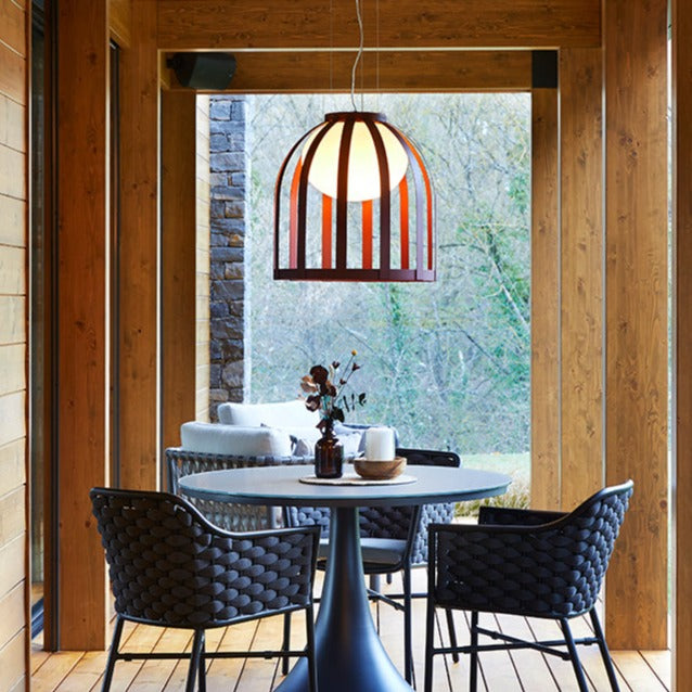 Bols pendant light in ox red over dining table outside