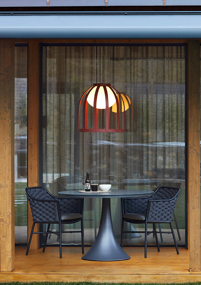 Bols pendant light in ox red over outdoor table