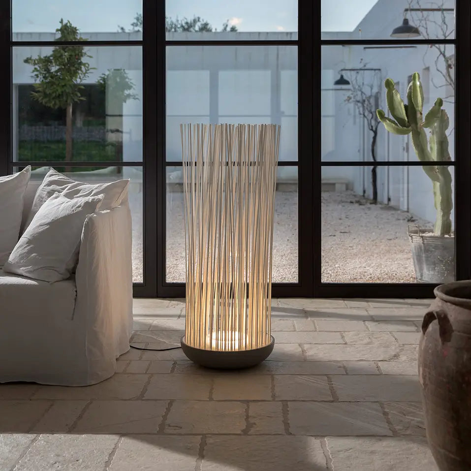 Don't Touch floor lamp by sofa on stone floor