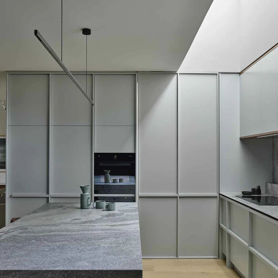 Highline Linear Pendant in Black over Grey Kitchen Island with Sage Green Cabinets