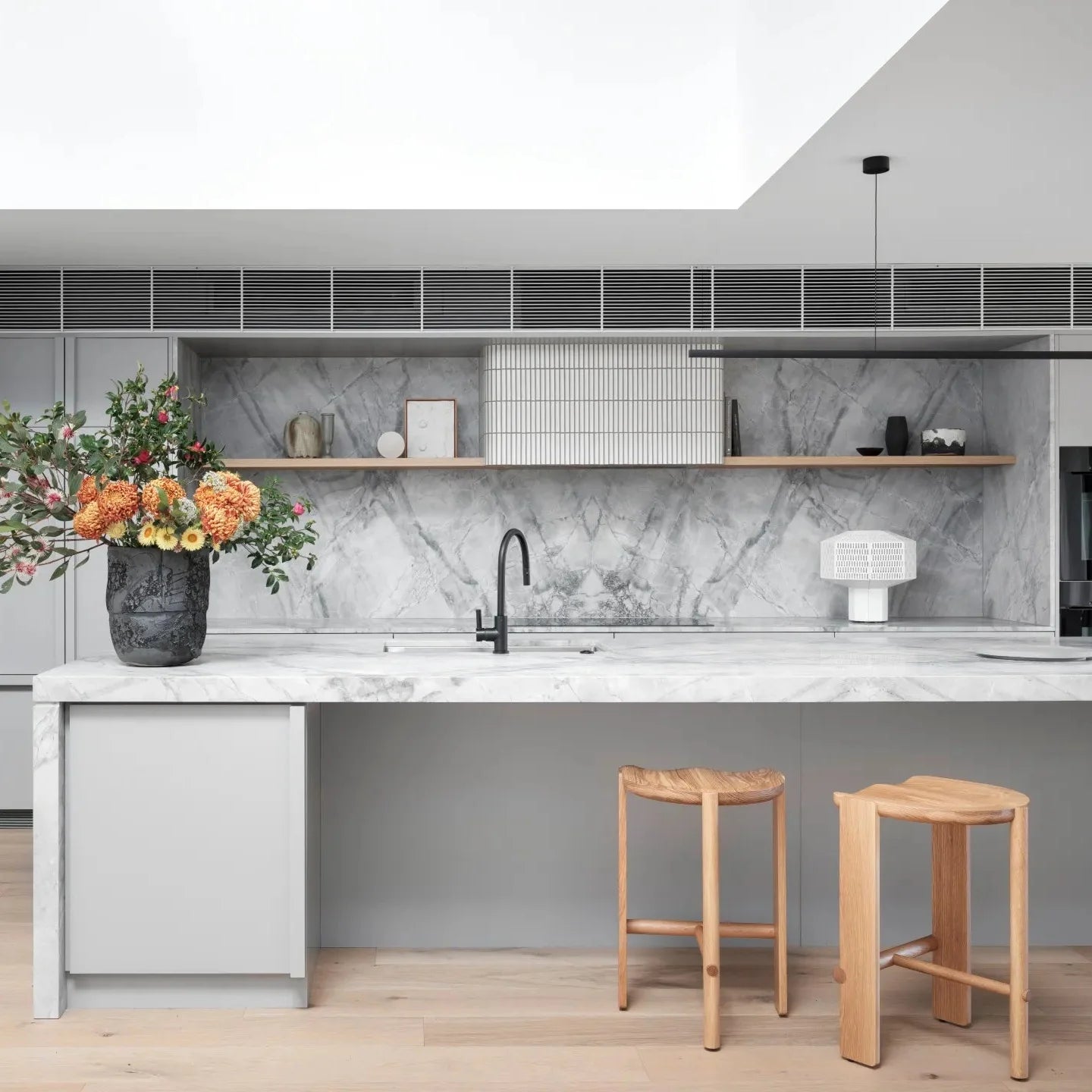 Highline Linear Pendant in Black over Kitchen Island with Sky Light
