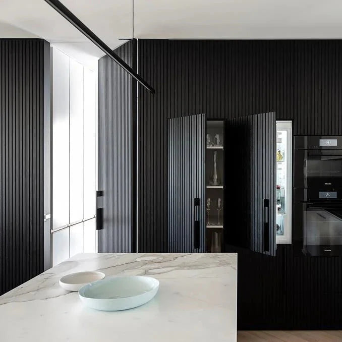 Highline Linear Pendant in Black over White Marble Kitchen Island with Black Cupboards