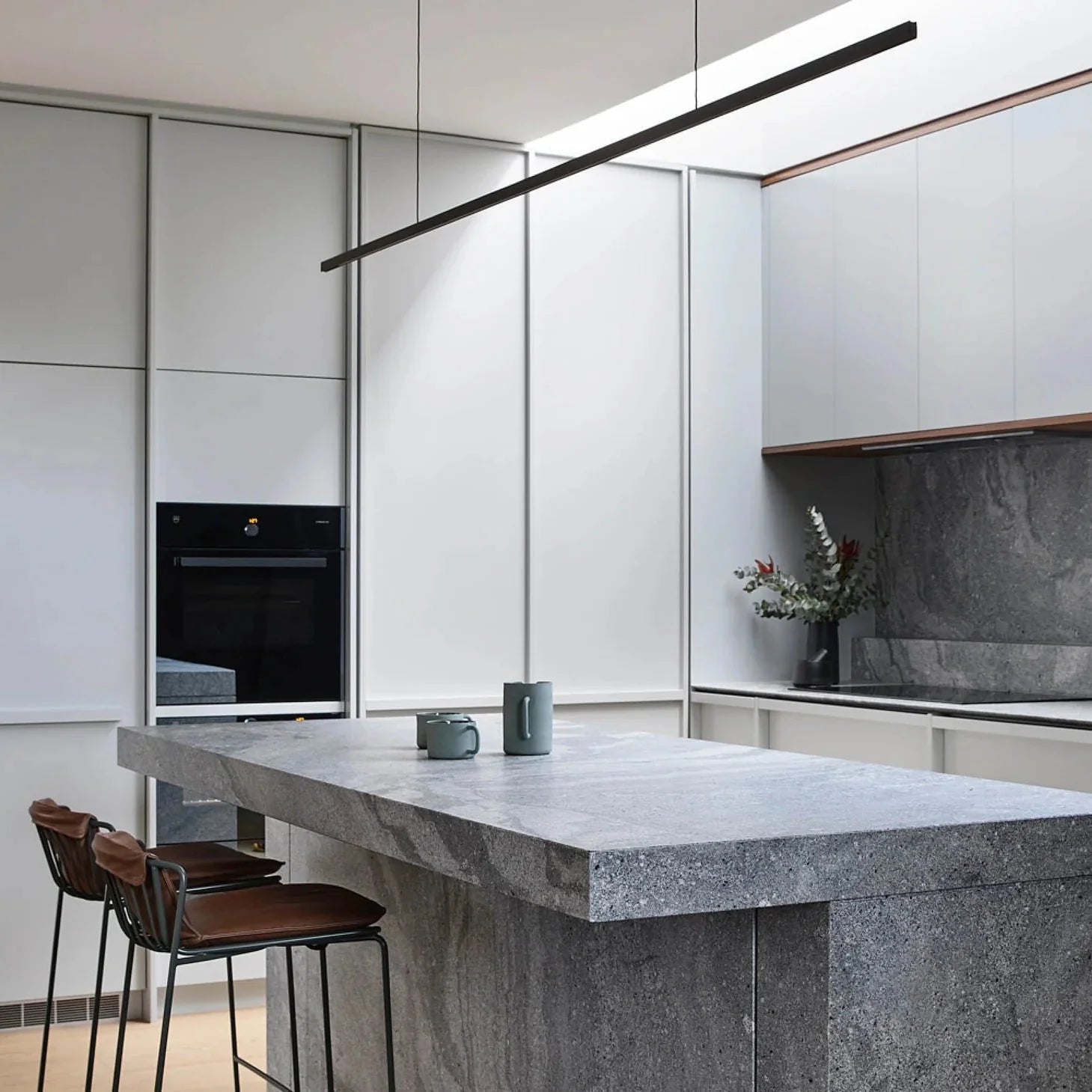 Highline Linear Pendant in Black with Grey Marble Kitchen Island and Backsplash