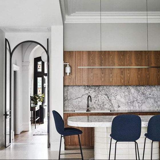 Highline Linear Pendant in Patina Brass over White Marble Kitchen Island with Wood Cupboards