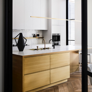 Highline Linear Pendant in Satin Brass with Black Vase on Kitchen Island