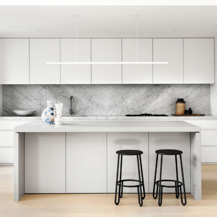Highline Linear Pendant in White with Recessed Canopy over White Kitchen Island and Marble Backsplash