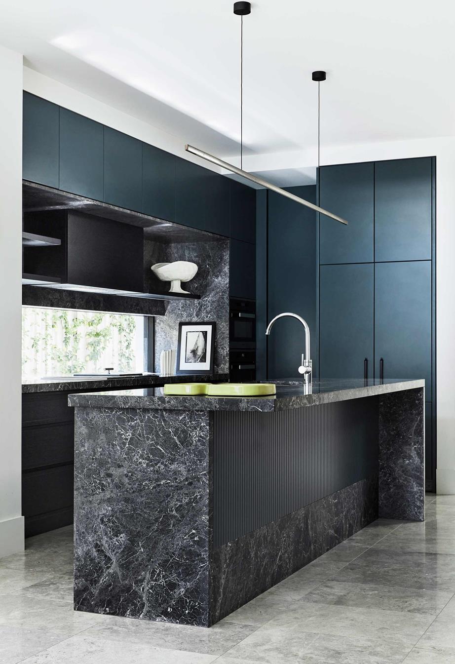 Highline Linear Pendant over Black Marble Kitchen Island with Blue Cabinets